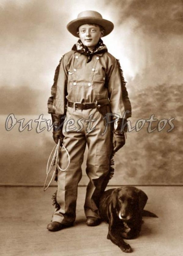 PHOTO OF A LITTLE YOUNG COWBOY AND HIS DOG  